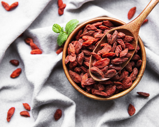 Dry red goji berries for a healthy diet on a fabric background
